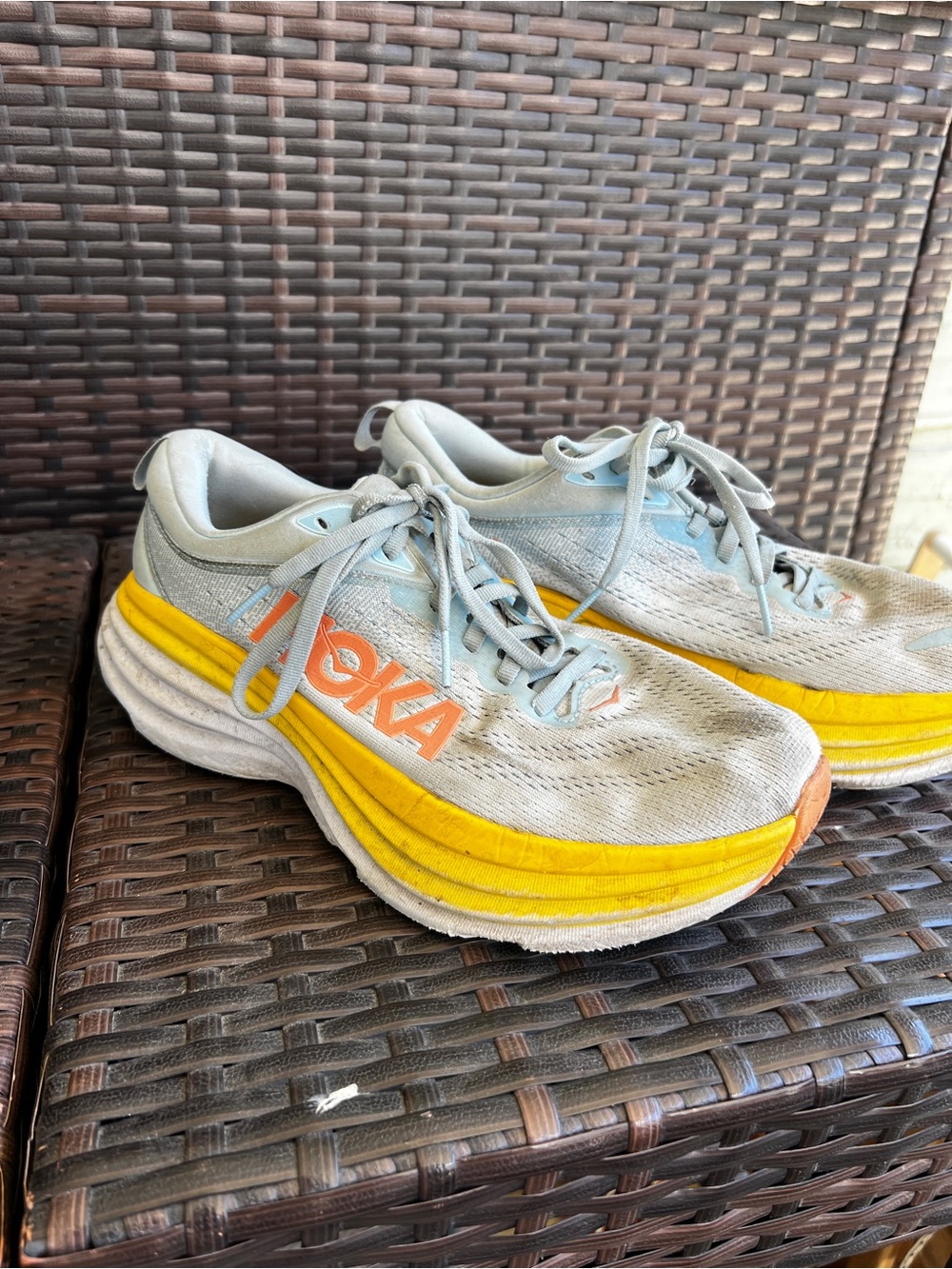 Hoka Lightweight Running Shoes in Light Blue with Yellow Accent pretty worn down
